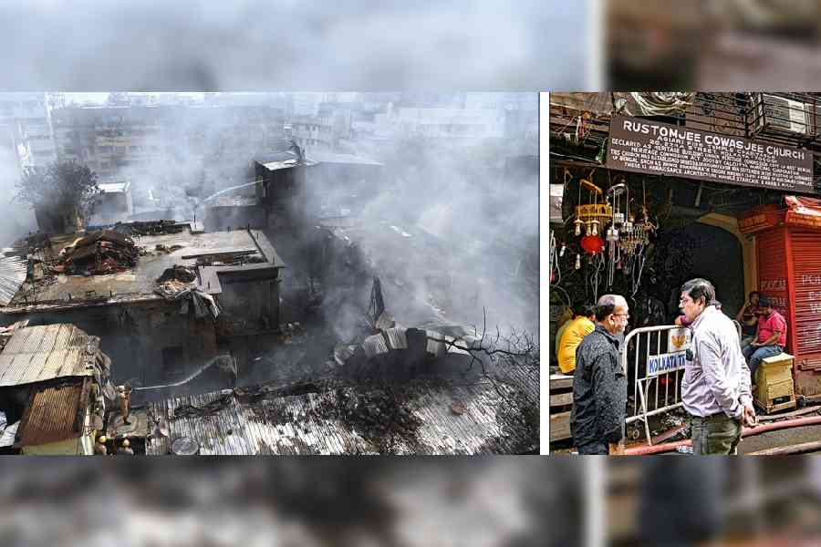 Firefighters at work as smoke rises from the blaze-hit Ezra Street buildings on Saturday morning. (right) The signboard of the 186-year-old Rustomjee Cowasjee Church