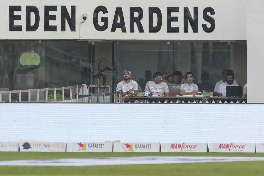 Front row from left, fielding coach T Dilip, batting coach Sitanshu Kotak, head coach Gautam Gambhir and others sit in the dugout on day two of the first Test cricket match of a series between India and South Africa, at the Eden Gardens.