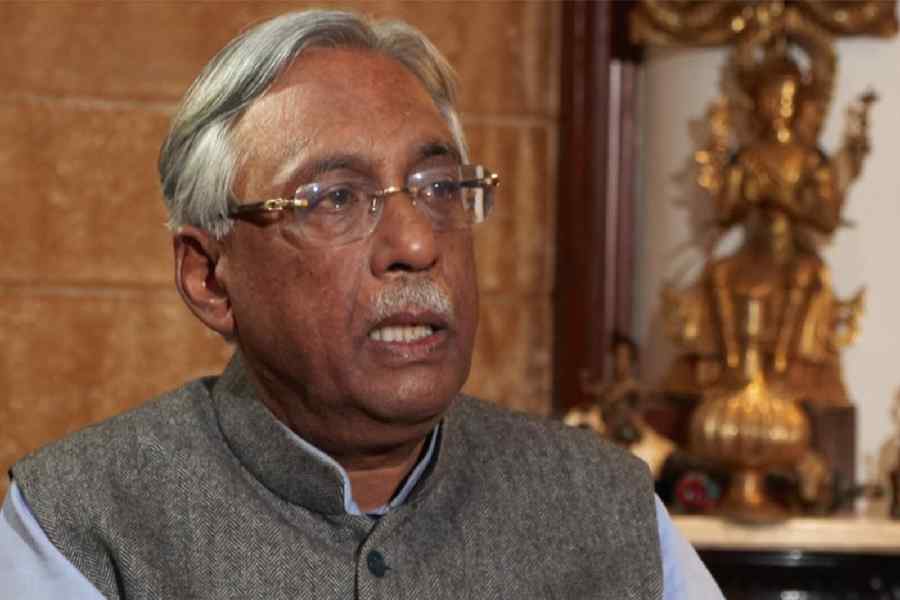 People show their ID cards as they wait in queues to cast their votes at a polling station during the second and final phase of the Bihar Assembly elections, in Gaya, Tuesday, Nov. 11, 2025.