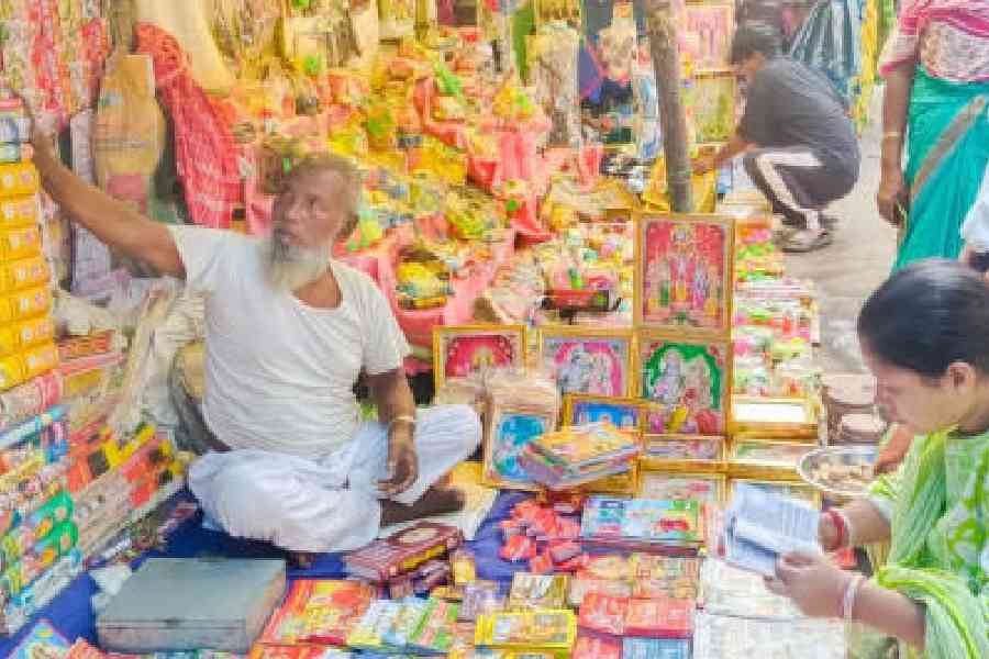 Taslim Sheikh sells Hindu religious books and illustrations in his stall at the ongoing Raas Mela in Cooch Behar. Picture by Main Uddin Chisti