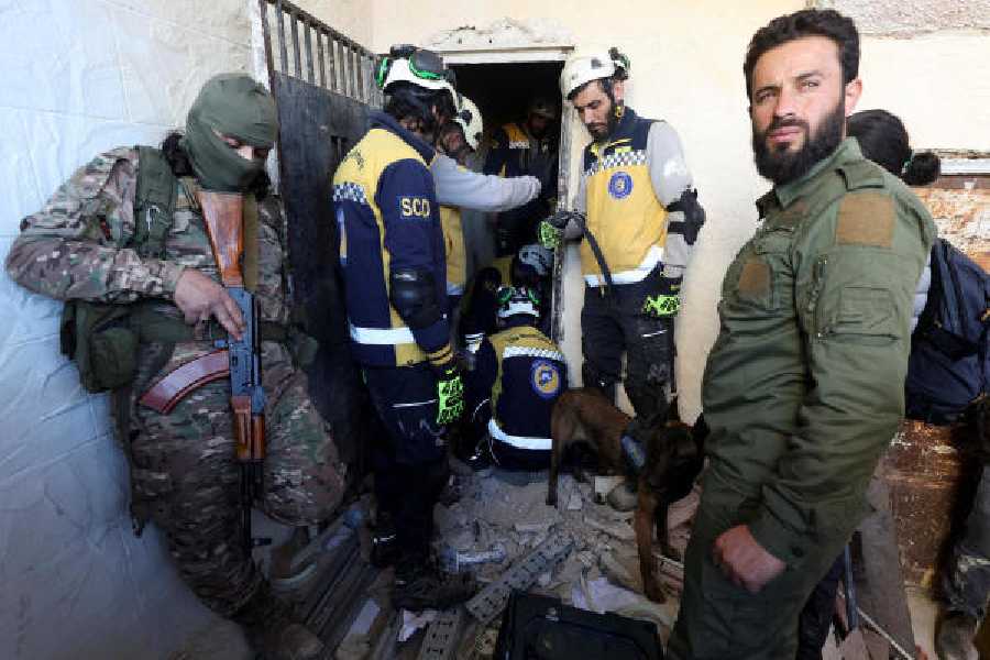 Members of the Syrian civil defence group, known as the White Helmets, search for prisoners at Sednaya jail on December 9, 2024.