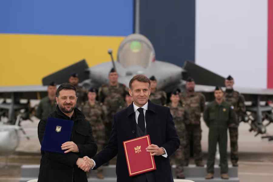 French President Emmanuel Macron and Ukrainian President Volodymyr Zelenskiy shake hands after signing an agreement at the Villacoublay air base near Paris, France, November 17, 2025.