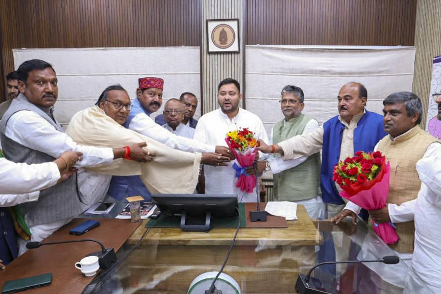 Newly elected RJD MLAs and others greet party leader Tejashwi Yadav after he was elected as the legislature party leader during a meeting, in Patna, Monday, Nov. 17, 2025.