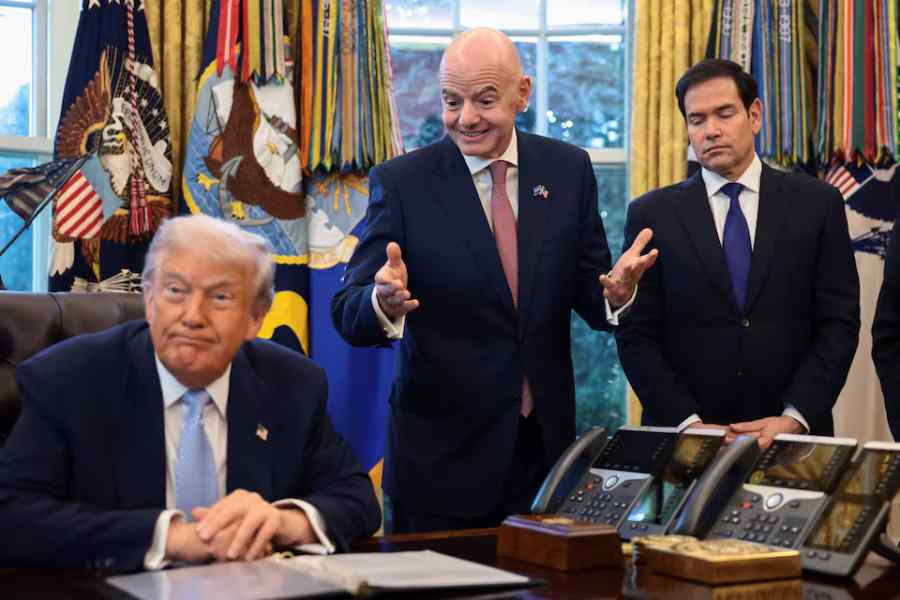 US President Donald Trump sits next to FIFA President Gianni Infantino and US Secretary of State Marco Rubio, as he meets with the White House Task Force on the FIFA World Cup 2026 in the Oval Office at the White House in Washington, D.C., US, November 17, 2025.