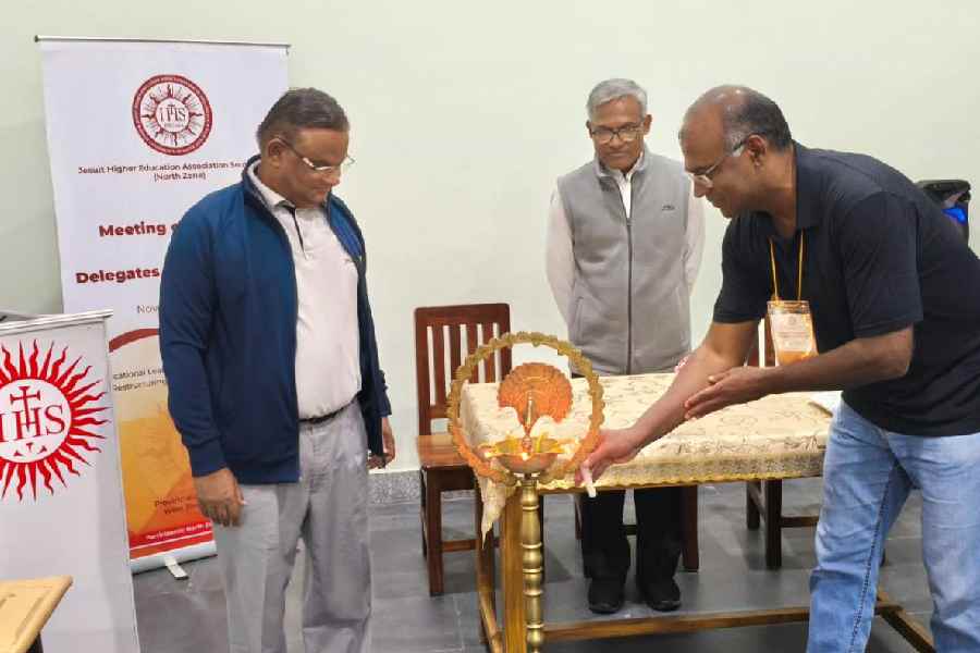 Fr Augustine Thomas, SJ, the principal of St Xavier’s College, Kathmandu, Nepal, lights the lamp at the inauguration of the conference, with Fr Shajumon C.K., SJ, the provincial superior of Darjeeling-Nepal Jesuit province (centre) and Fr. Dominic Savio, SJ, the principal of St. Xavier’s College (autonomous), Calcutta (left) at North Bengal St Xavier’s College in Matigara on Friday 