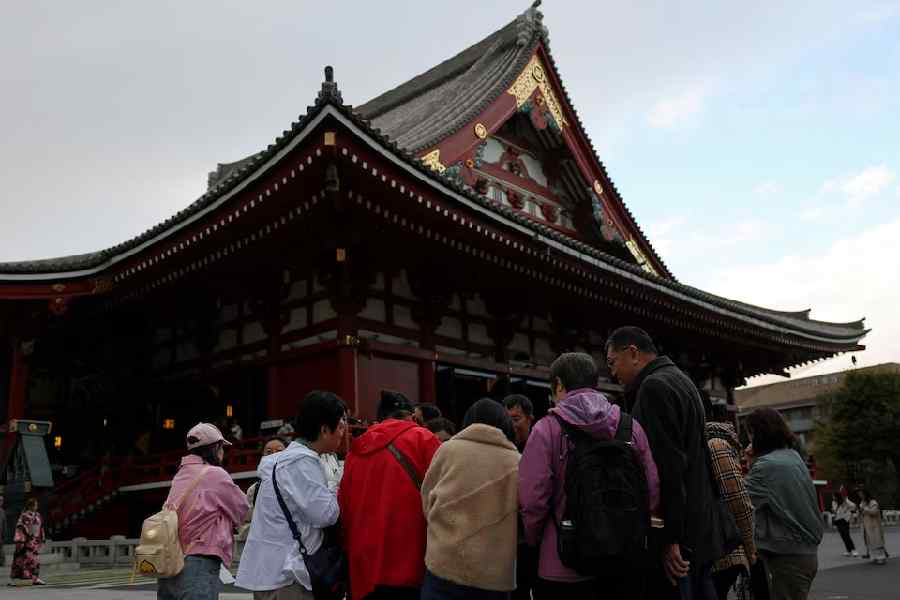 A Chinese tourist group stands near the Sensoji temple in Tokyo.