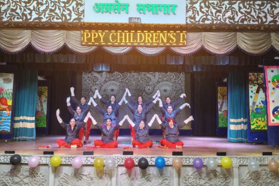 The celebration continued with soulful cultural performances by teachers, including a tribute dance to Zubeen Garg and Bhupen Hazarika, and a homage to Late Shri B. D. Tikmany. Folk dances, instrumental fusions and musical renditions captivated the audience. The event concluded with a thanksgiving speech by the Vice-Principal, emphasising responsibility and self-awareness, followed by drumbeats for the National Anthem and biscuit packets distributed as tokens of love.