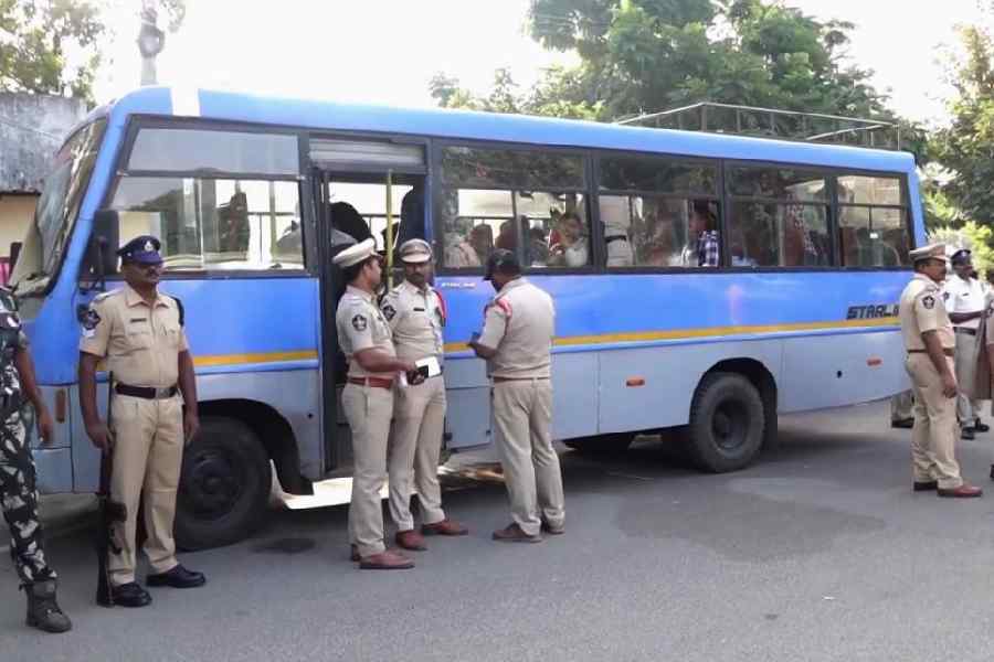 Police personnel stand beside a vehicle after arresting Maoists from Eluru and New Auto Nagar in Gannavaram, Vijayawada, Andhra Pradesh, Wednesday, Nov. 19, 2025. A large amount of arms and ammunition was recovered from the Maoists.