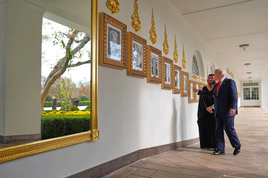 President Donald Trump and Saudi Arabia's Crown Prince Mohammed bin Salman walk along the Colonnade at the White House, Tuesday, Nov. 18, 2025, in Washington.