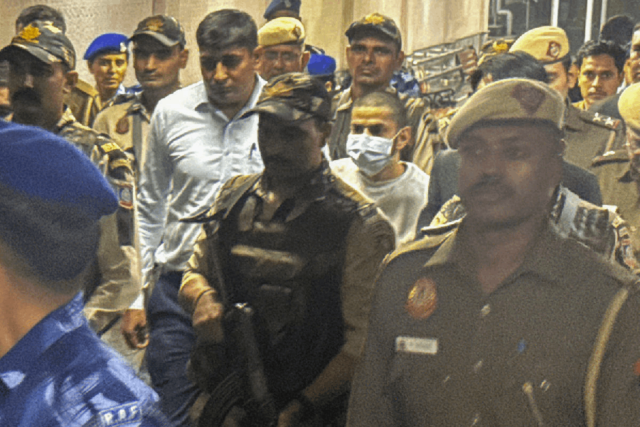 Gangster Anmol Bishnoi, in mask, while being produced in the Patiala House Court, in New Delhi, Wednesday, Nov. 19, 2025. The court on Wednesday sent Bishnoi, the brother and close aide of gangster Lawrence Bishnoi, to 11 days of NIA custody. The federal agency had arrested him upon his deportation from the US.
