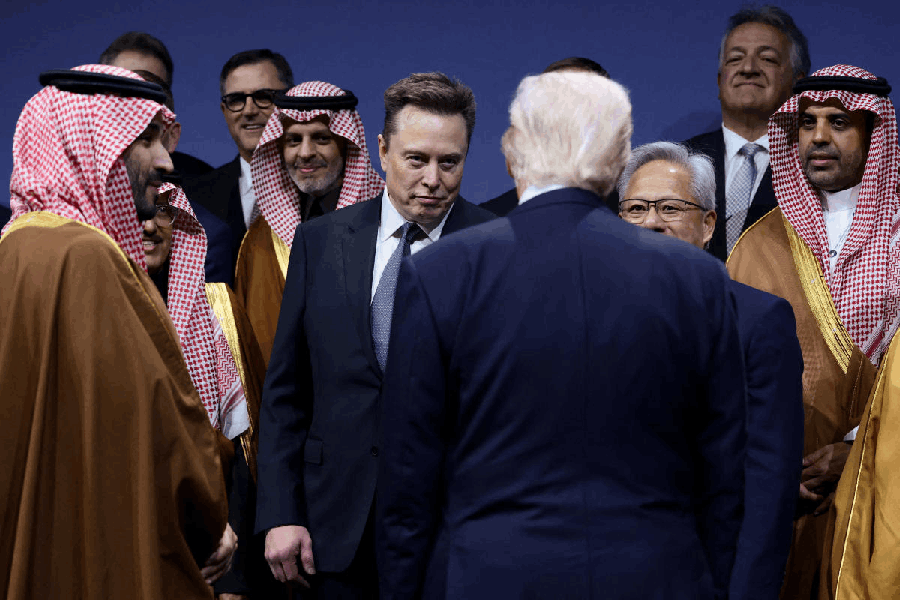 Crown Prince and Prime Minister Mohammed bin Salman of Saudi Arabia, Jensen Huang, CEO of Nvidia, and Elon Musk look at U.S. President Donald Trump during the U.S.-Saudi Investment Forum in Washington, D.C., U.S., November 19, 2025.