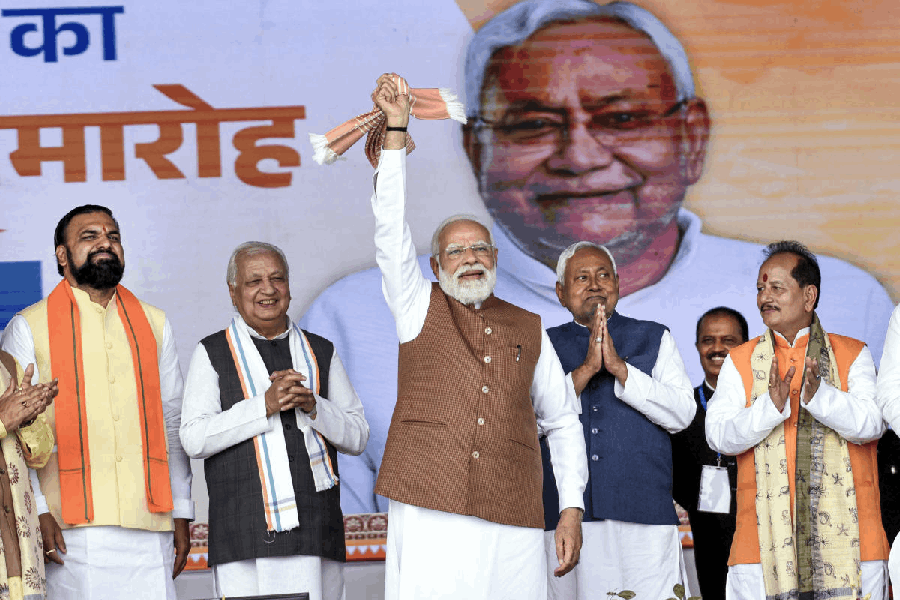 Prime Minister Narendra Modi waves a ‘gamcha’ during the swearing-in ceremony of NDA government, at Gandhi Maidan in Patna, Thursday, Nov. 20, 2025. Bihar Governor Arif Mohammad Khan, newly sworn-in state Chief Minister Nitish Kumar, state Ministers Samrat Choudhary, Vijay Sinha also seen.
