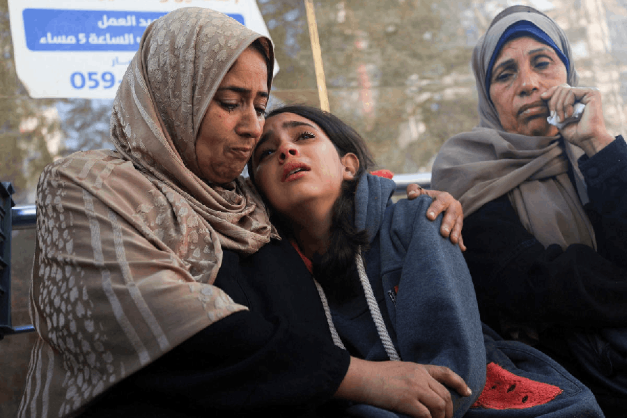 Mourners react as they attend the funeral of Palestinians who, according to medics, were killed in overnight Israeli strikes, at Al-Shifa Hospital in Gaza City, November 20, 2025.