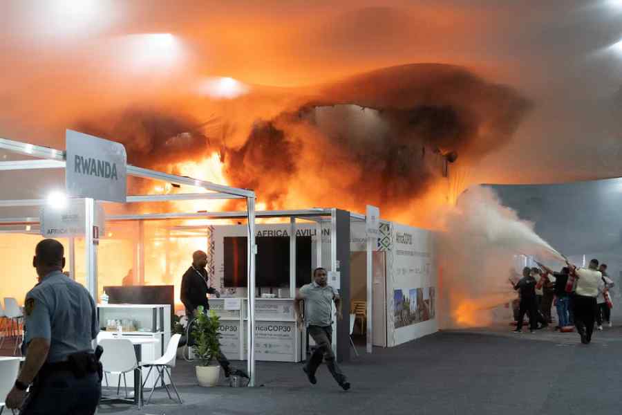 People use fire extinguishers to put out a fire at the Pavilion of Countries in the Blue Zone at the United Nations Climate Change Conference (COP30) in Belem, Brazil, November 20.