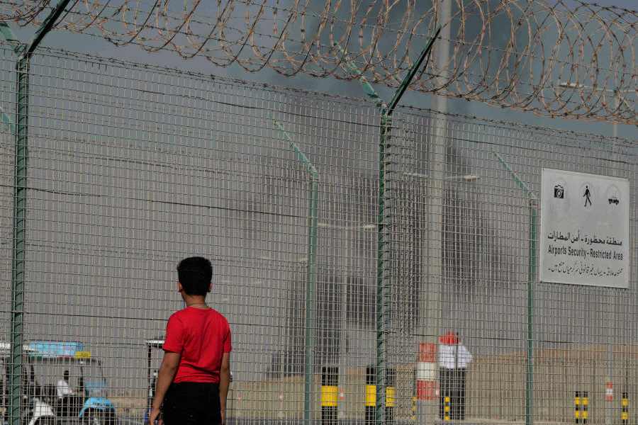 A bystander watches as an Indian HAL Tejas crashes during a demonstration at the Dubai Air Show, at Al Maktoum International Airport at Dubai World Central, Dubai, United Arab Emirates, Friday Nov. 21, 2025.
