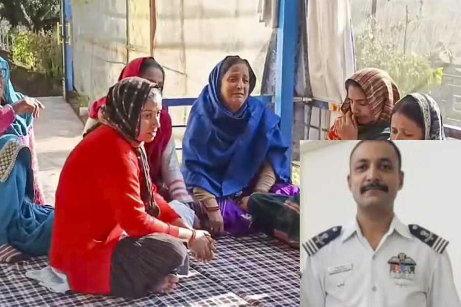 Family members of Wing Commander Namansh Syal, a fighter pilot who was killed after an IAF aircraft crashed during the Dubai Airshow, mourn at his residence, at Nagrota Bagwan in Kangra district [In set: Wing Commander Namansh Syal]