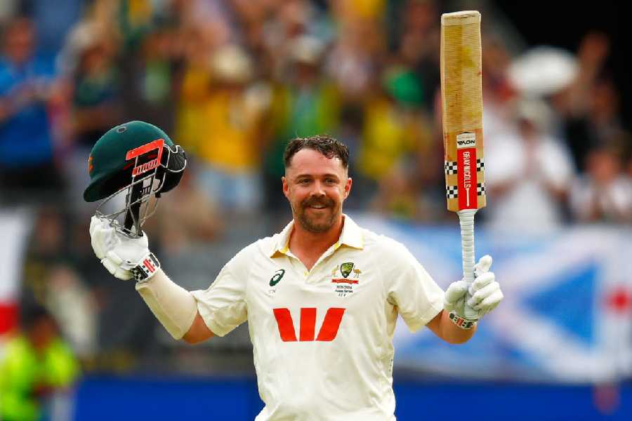 Australia's Travis Head celebrates his century on day two of the first Ashes cricket test match between Australia and England in Perth