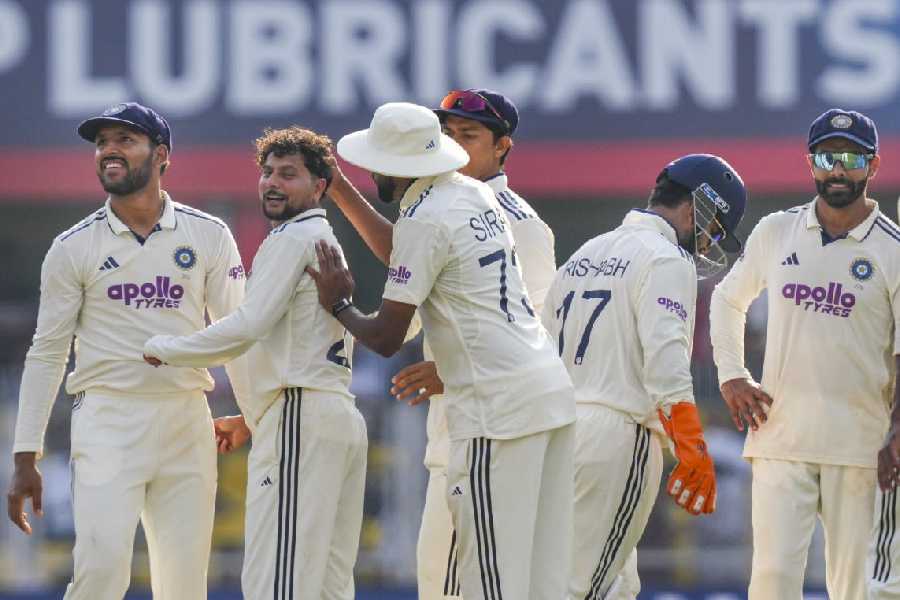 India's Kuldeep Yadav celebrates with teammates after taking the wicket of South Africa's Tristan Stubbs during the first day of the second Test cricket match between India and South Africa, at ACA Stadium, Barsapara in Guwahati