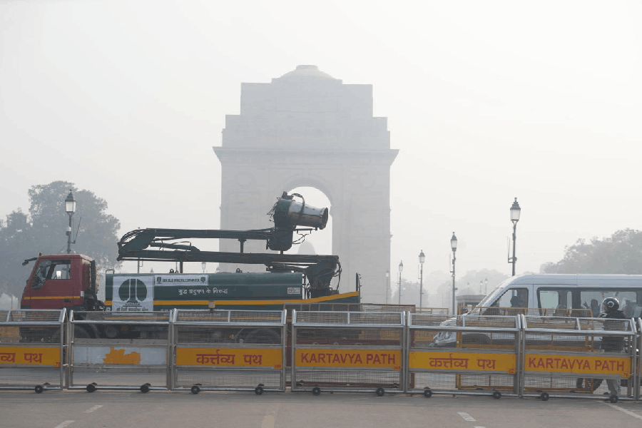 An NDMC vehicle mounted with an anti-smog gun moves past India Gate, in New Delhi, Saturday, Nov. 22, 2025.