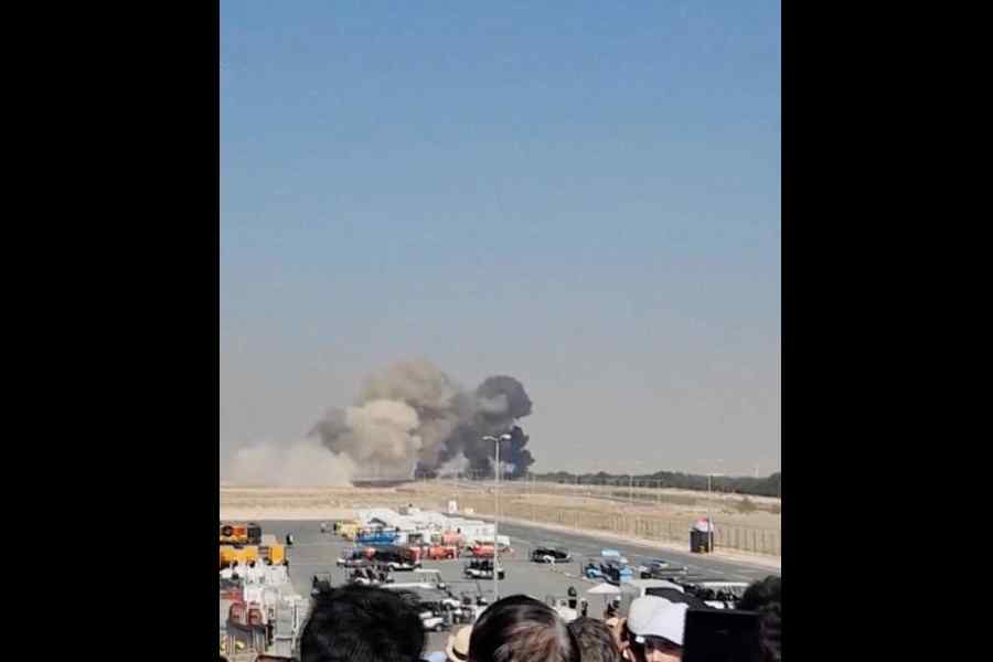 Smoke billows after the Tejas fighter jet lost altitude and crashed during an aerial display at the Dubai Air Show on Friday. 