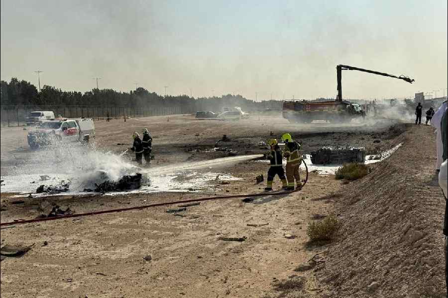 Firefighters work at the site of a crash involving an Indian-made HAL Tejas fighter jet at the Dubai Air Show, United Arab Emirates, November 21, 2025, in this handout picture obtained from social media.