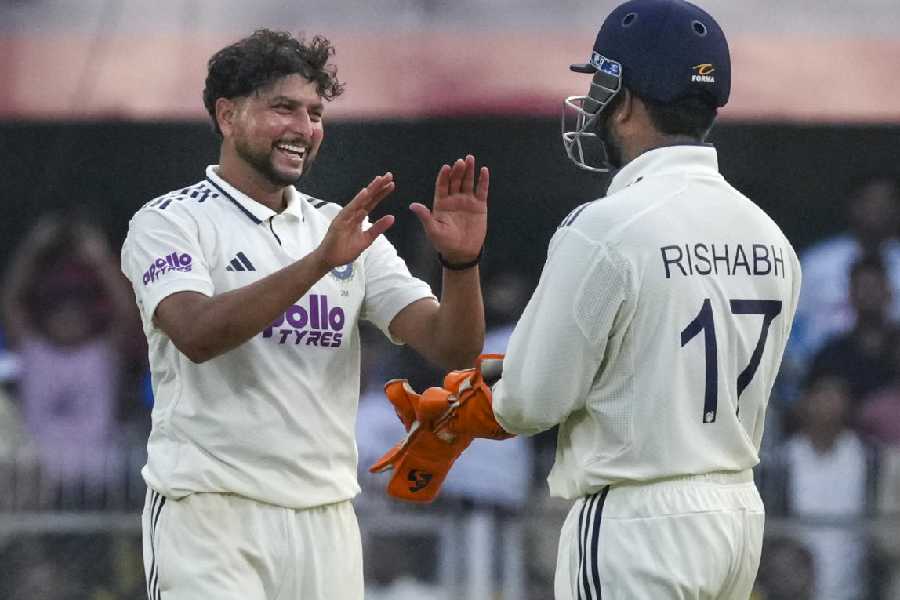 India's captain Rishabh Pant with Kuldeep Yadav celebrates after the wicket of South Africa's Marco Jansen during the day two of the second Test cricket match of a series between India and South Africa, at ACA Stadium in Guwahati