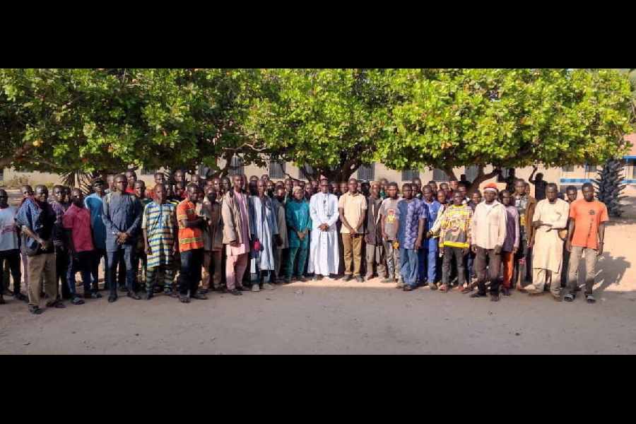 Bishop Bulus Yohanna and the parents of children from the Catholic St. Mary's School in Papiri, Niger state, Nigeria, from which more than 300 children and staff are reported to have been kidnapped on November 21, 2025, pose in an undated handout image obtained by Reuters on November 23, 2025.