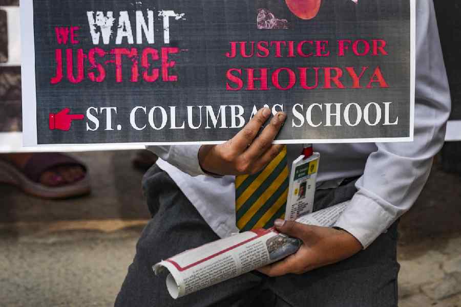A school student participates in a protest by parents of a Class 10 student