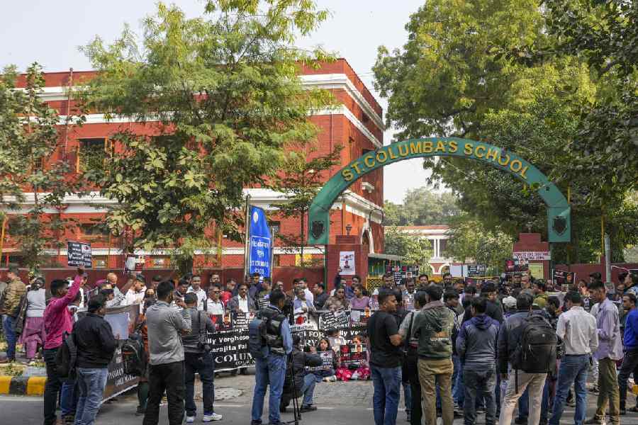 People participate in a protest by school students and parents of a Class 10 student, demanding strict action against those responsible, outside St Columba's School, in New Delhi