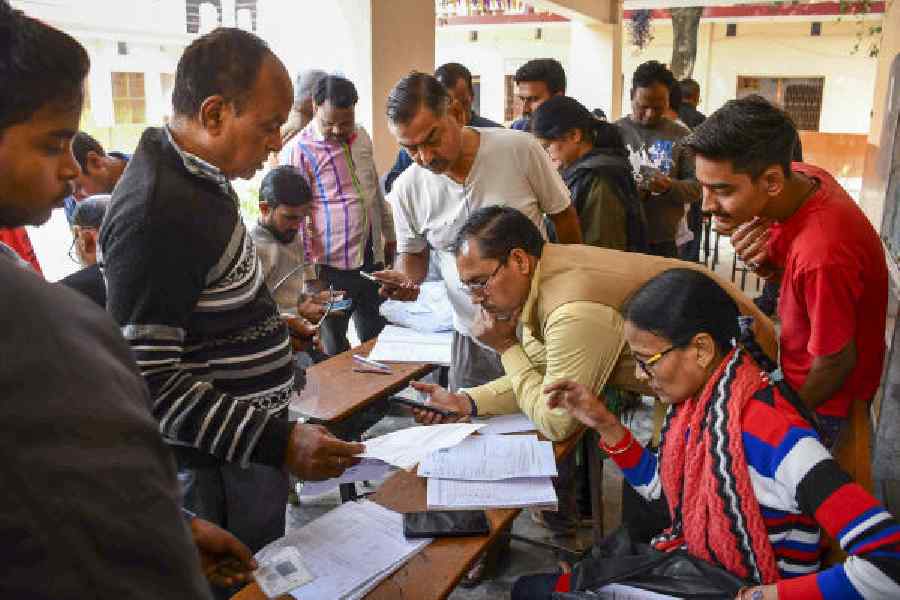 Booth-level officers check and collect enumeration forms in Allahabad on Sunday.