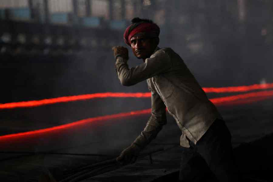 A worker in a steel processing production line in Mandi.
