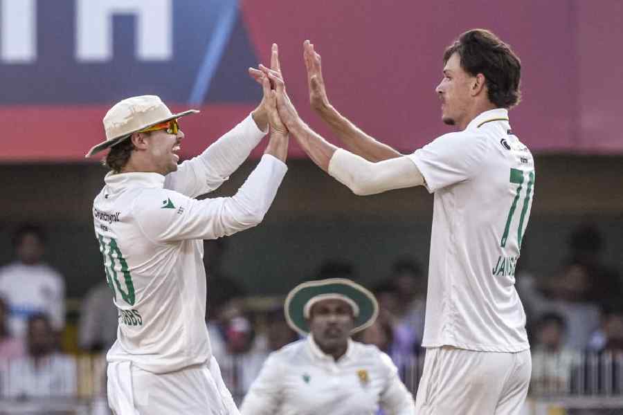 Marco Jansen (right) celebrates with a teammate one of his six wickets on Monday.