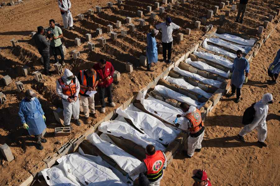 Bodies of unidentified Palestinians returned from Israel as part of the ceasefire deal are buried in Deir al-Balah, Gaza Strip, Sunday, Nov. 23, 2025.