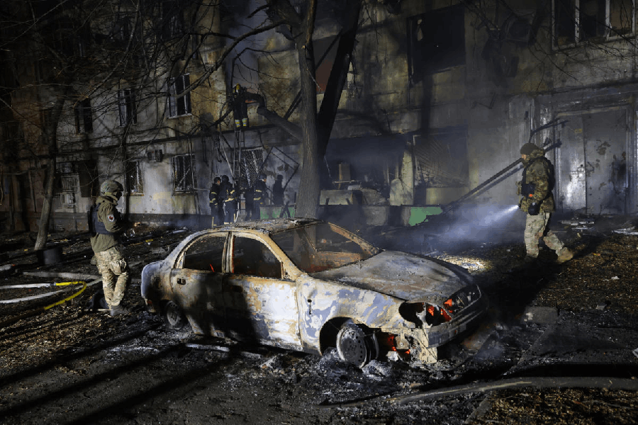 Rescue workers try to put out a fire of a residential building burning after a Russian attack on Zaporizhzhia, Ukraine, Wednesday, Nov. 26, 2025.