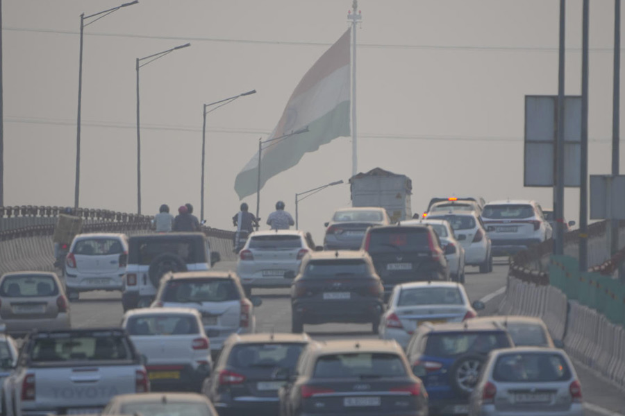Vehicles move amid air pollution in New Delhi.
