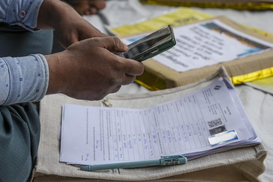 A Booth Level Officer (BLO) at work during a sit-in demonstration near the Election Commission’s (ECI) office over "excessive work pressure" and "inhuman workloads" during the ongoing process of the special intensive revision (SIR) of electoral rolls, in Kolkata, West Bengal, Wednesday, Nov. 26, 2025.