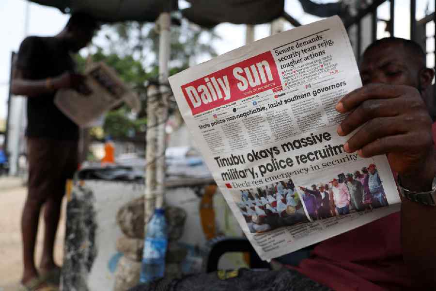 People read newspapers at a roadside newspaper stand in Ikoyi Lagos, Nigeria on November 27.