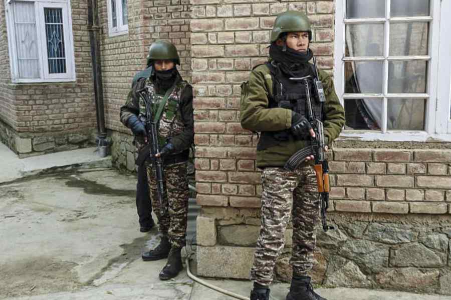 CRPF personnel cordon off the residence of a person linked to the banned Jamaat-e-Islami during a search operation in Pulwama on Thursday