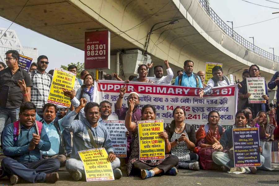 Candidates who passed the 2016 Upper Primary recruitment test participate in a protest march demanding immediate recruitment, in Kolkata, Monday, Nov. 24, 2025.