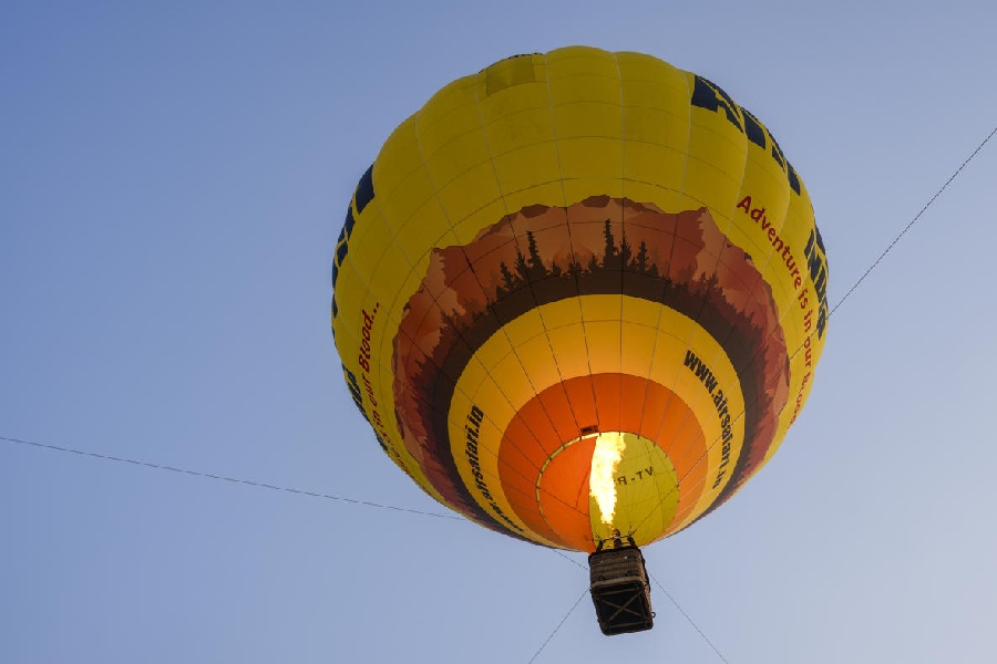 A hot air balloon glides in the air during a trial run of the hot air balloon ride at Baansera park, in New Delhi, Tuesday, Nov. 25, 2025.