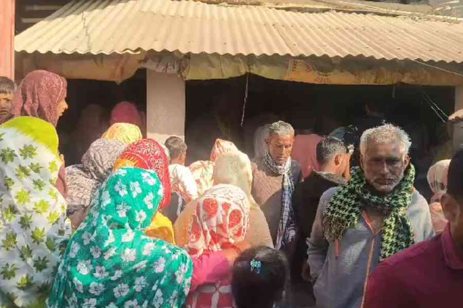 Family members and neighbours of Zakir Hossain at Khargram in Murshidabad on Friday.