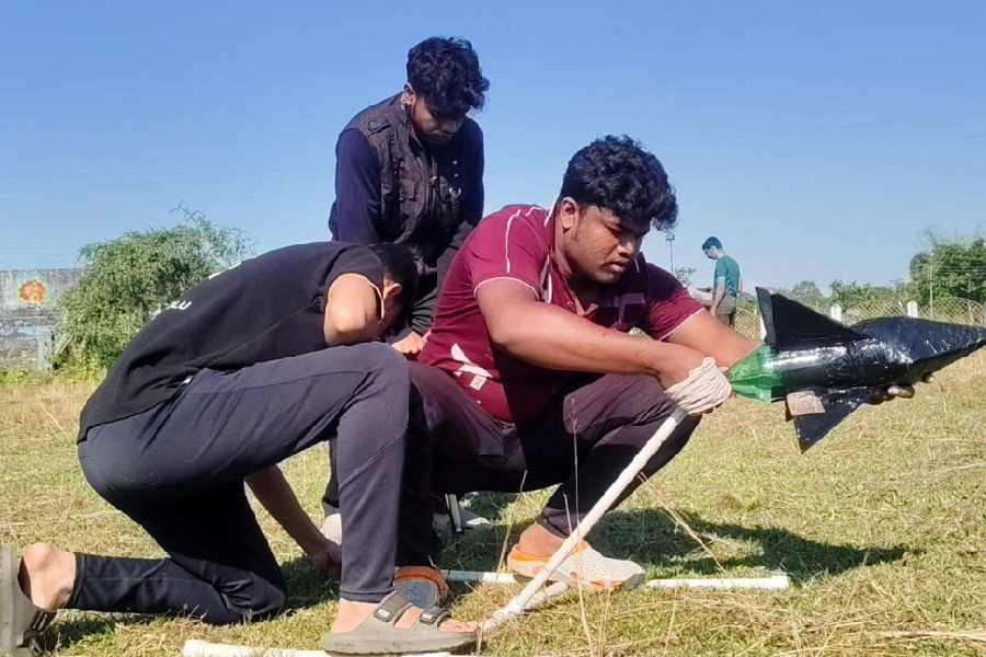 A group of students of Jalpaiguri Government Engineering College prepares to launch a makeshift rocket during the institution’s annual fest at Jalpaiguri on Friday.
