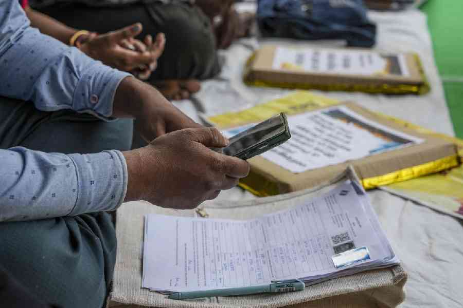 A Booth Level Officer (BLO) at work during a sit-in demonstration near the Election Commission’s (ECI) office over "excessive work pressure" and "inhuman workloads" during the ongoing process of the special intensive revision (SIR) of electoral rolls, in Kolkata, West Bengal