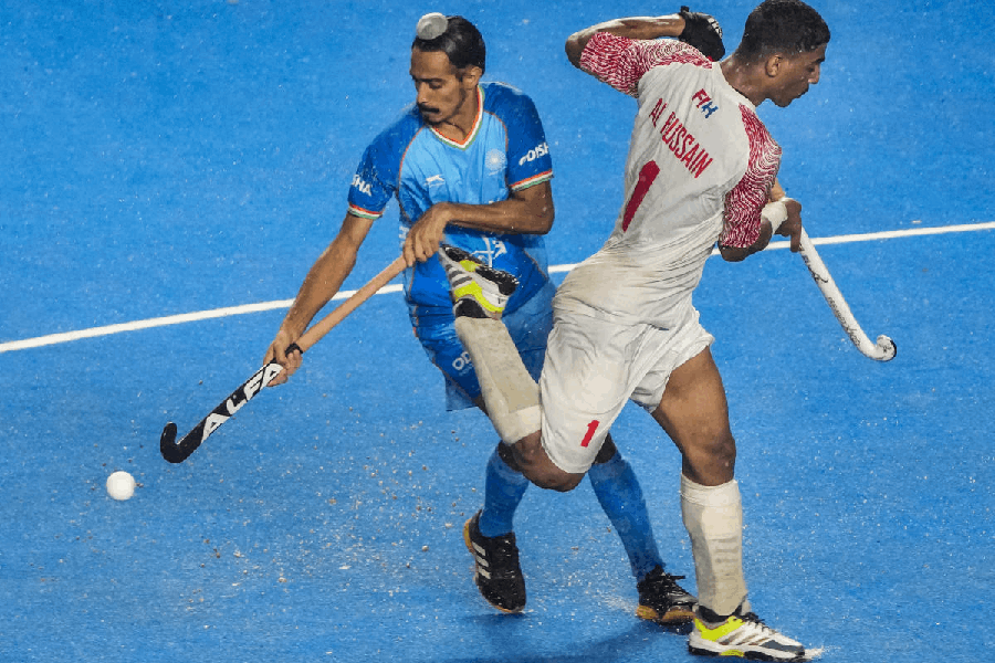 Players of India (in blue) and Oman vie for the ball during their FIH Hockey Men's Junior World Cup 2025 match, at Mayor Radhakrishnan Hockey Stadium, in Chennai, Tamil Nadu, Saturday, Nov. 29, 2025.