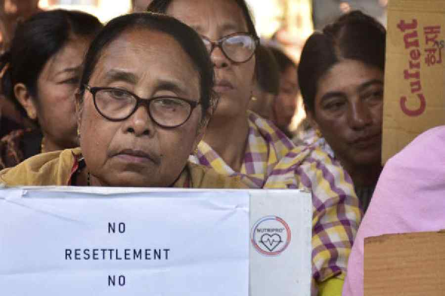 An Internally Displaced Person (IDP) holds a placard during a protest opposing the annual ‘Sangai Festival’, in Imphal, Manipur on Wednesday