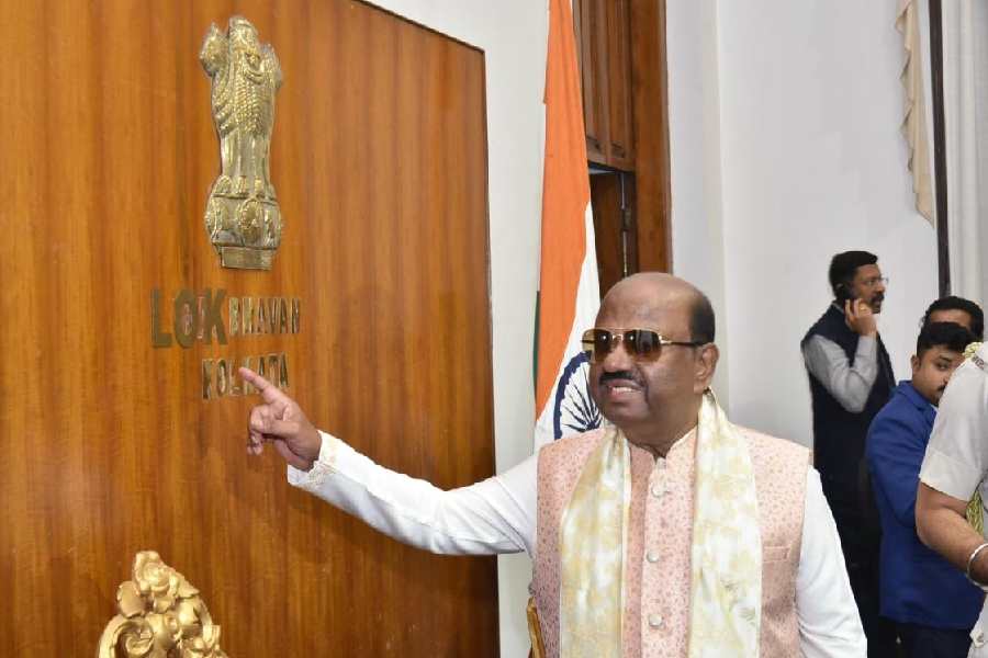 Governor CV Ananda Bose shows the new Lok Bhavan nameplate on the wall of his official residence on Saturday