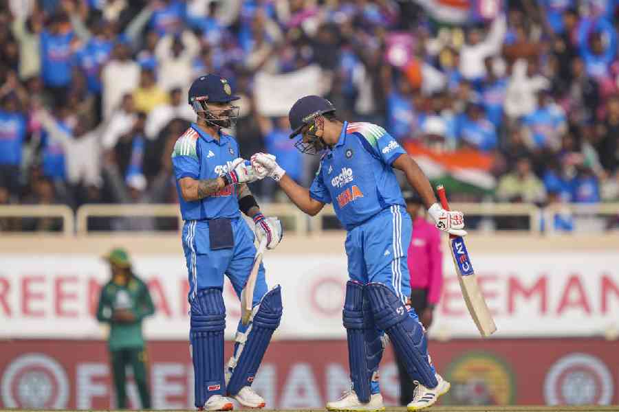 India's Virat Kohli, left, celebrates his half century with Rohit Sharma during the first ODI cricket match of a series between India and South Africa, at JSCA International Stadium Complex, in Ranchi
