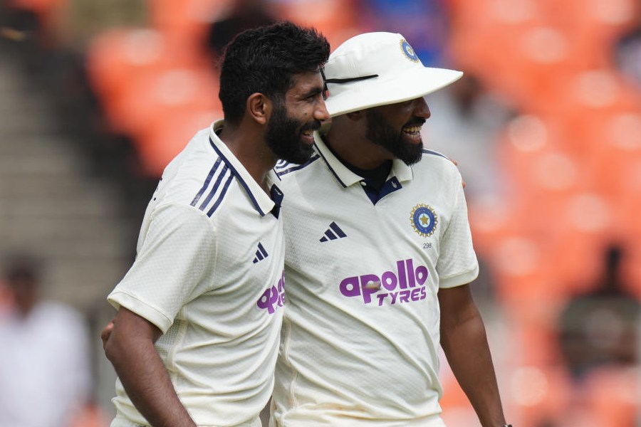 India's Jasprit Bumrah, left, and Mohammed Siraj celebrates the dismissal of West Indies' Johann Layne on the first day of the first Test cricket match between India and West Indies at Narendra Modi Stadium in Ahmedabad, India, Thursday, Oct. 2, 2025.