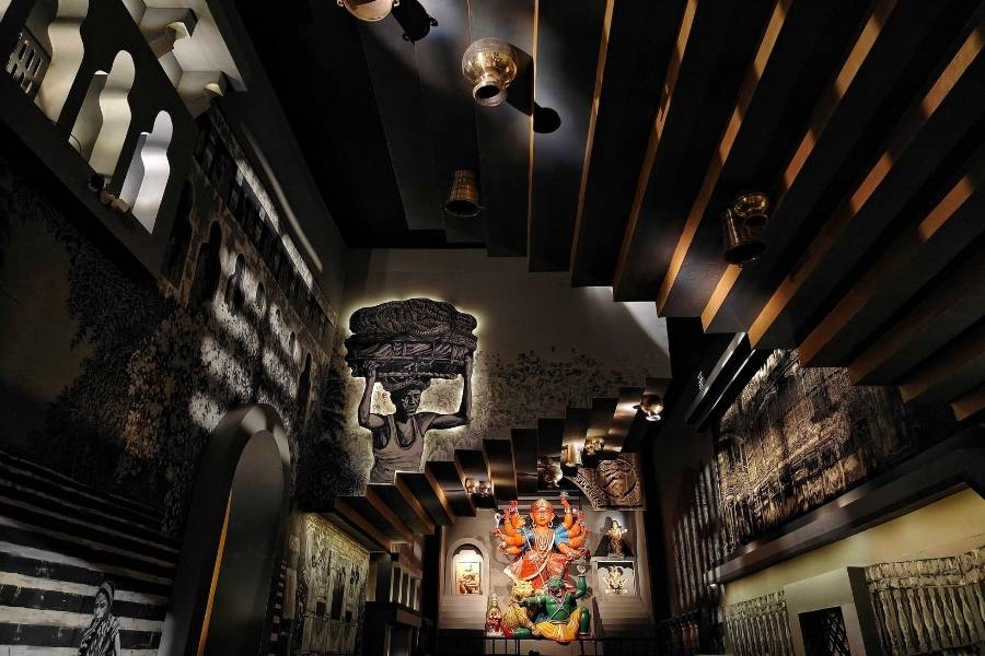 ‘Atho Ghat Kotha’ evokes the old river ghats, with sculpted steps, trees and textured walls recreating a disappearing side of Kolkata