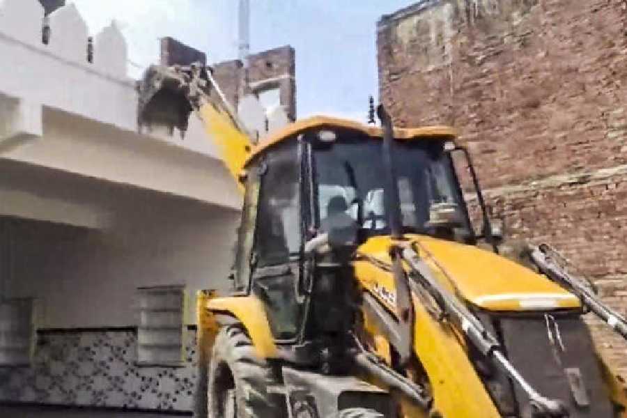 The marriage hall adjacent to the mosque being demolished in Sambhal on Thursday.